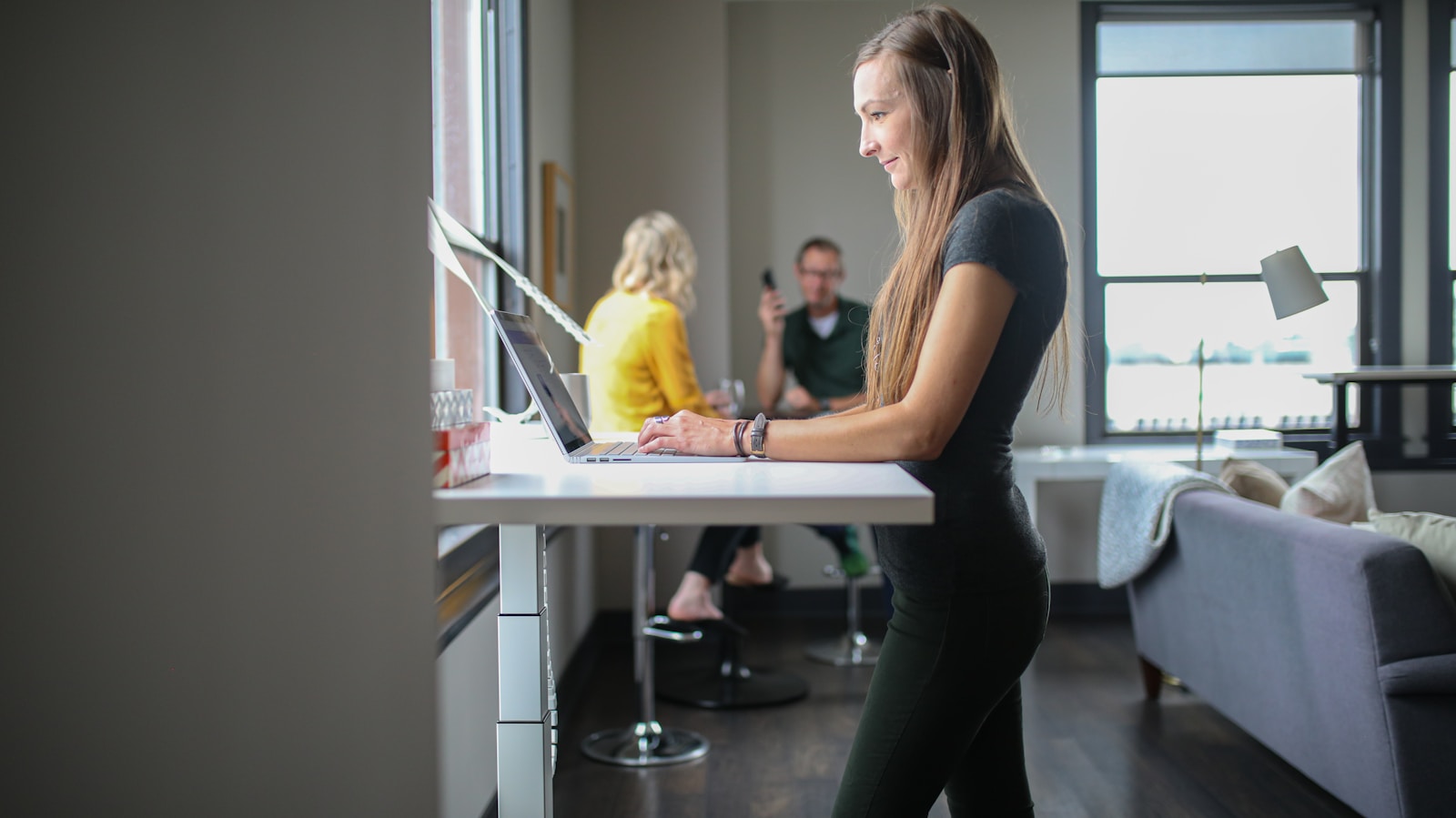 woman in black tank top and black pants sitting on chair